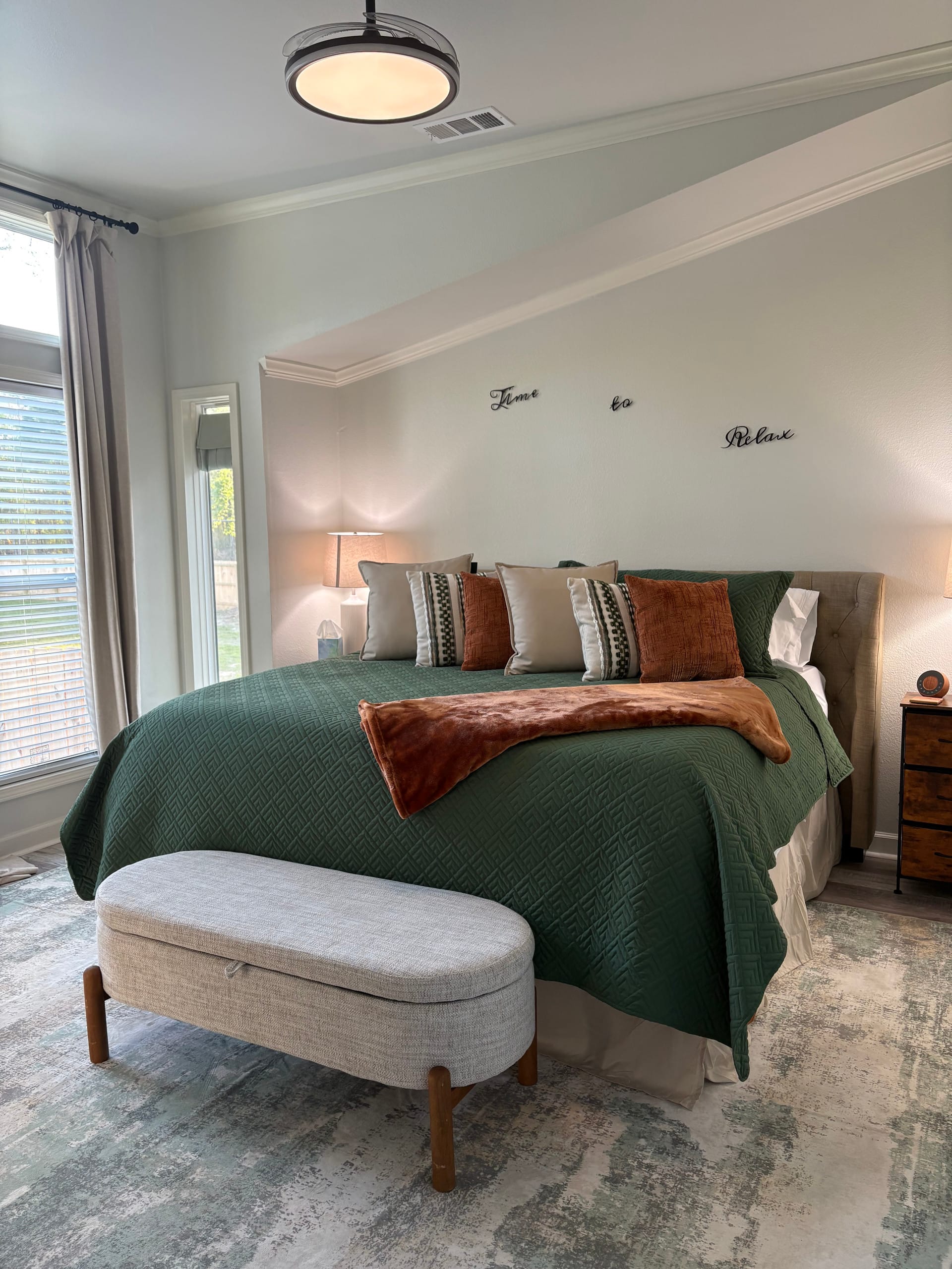 Bedroom with ceiling fan and extra pillows