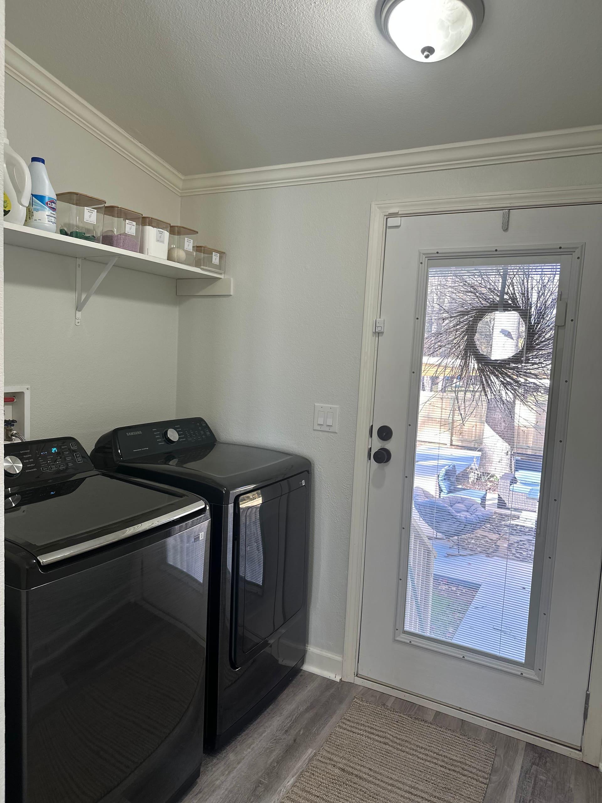 Laundry room with washer, dryer, and storage